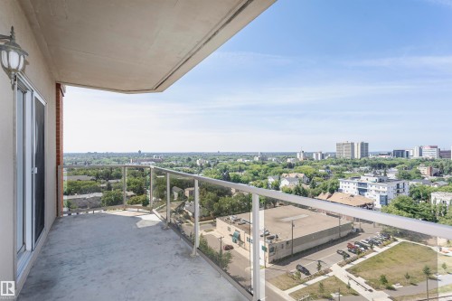 Private balcony featuring a concrete surface, clear glass railing, and attached wall sconce - 1701 10649 Saskatchewan Drive, Edmonton, AB - Outdoor With View