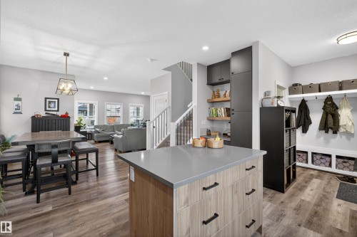 Kitchen island with a grey countertop and wood-finish cabinetry - 53 Wingate Way, Fort Saskatchewan, AB - Indoor