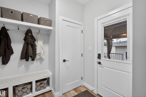 Mudroom featuring a built-in bench with storage cubbies, overhead shelving, and coat hooks - 53 Wingate Way, Fort Saskatchewan, AB - Indoor Photo Showing Other Room