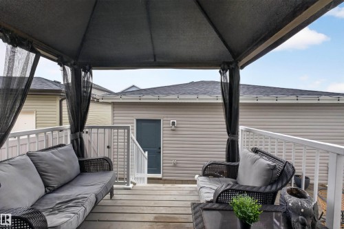 Spacious outdoor deck featuring wood-finish flooring and white railings - 53 Wingate Way, Fort Saskatchewan, AB - Outdoor With Deck Patio Veranda With Exterior
