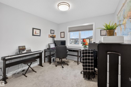 Carpeted room featuring light gray walls, a window with horizontal blinds, and a flush mount ceiling light - 53 Wingate Way, Fort Saskatchewan, AB - Indoor Photo Showing Office