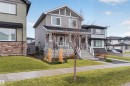 Two-story residence featuring a covered front porch with stone accents - 53 Wingate Way, Fort Saskatchewan, AB  - Outdoor With Facade 