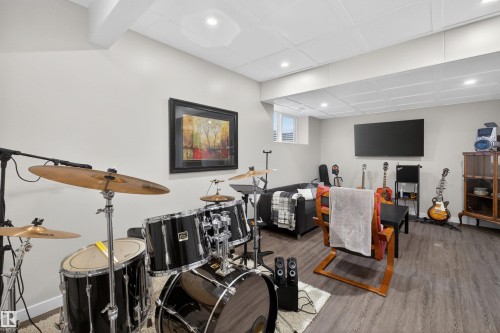 Finished lower level featuring recessed lighting, a drop ceiling, and wood-finish flooring - 53 Wingate Way, Fort Saskatchewan, AB - Indoor