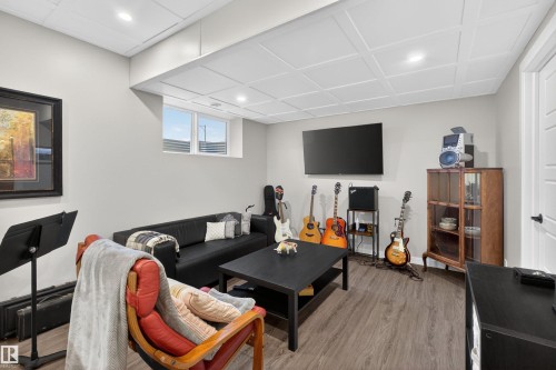 Finished room featuring wood-finish flooring, recessed lighting, and a drop-panel ceiling - 53 Wingate Way, Fort Saskatchewan, AB - Indoor