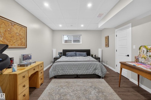 Spacious room featuring wood-finish flooring, recessed lighting, and a drop ceiling - 53 Wingate Way, Fort Saskatchewan, AB - Indoor Photo Showing Bedroom