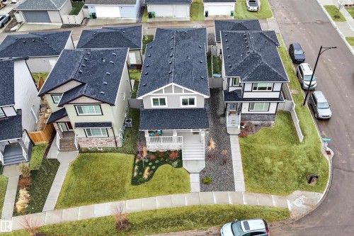 Contemporary two-story residence featuring a dark shingle roof, light siding, and stone accents - 53 Wingate Way, Fort Saskatchewan, AB - Outdoor