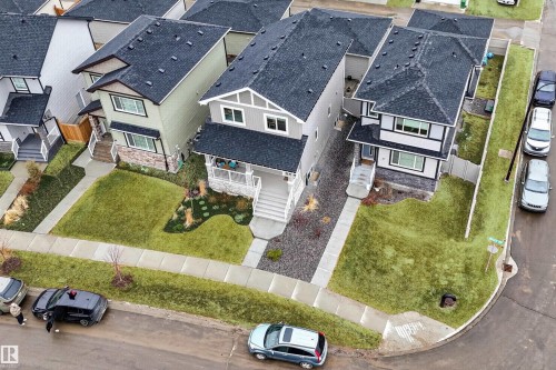 Gable-roofed residence with stone accenting, dark shingles, and a covered front entry - 53 Wingate Way, Fort Saskatchewan, AB - Outdoor