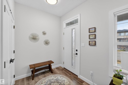 Entryway featuring a white door with decorative glass inserts and transom window - 53 Wingate Way, Fort Saskatchewan, AB - Indoor Photo Showing Other Room
