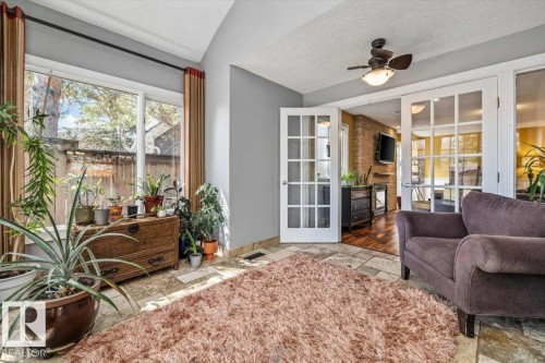 Sunroom featuring tiled flooring and a ceiling fan - 6003 176 Street, Edmonton, AB - Indoor Photo Showing Living Room