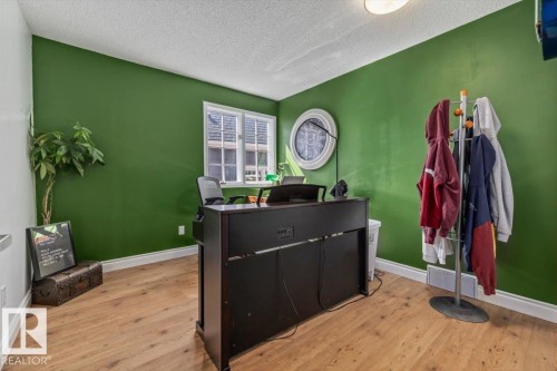 Room featuring wood-finish flooring and a single window with white trim - 6003 176 Street, Edmonton, AB - Indoor