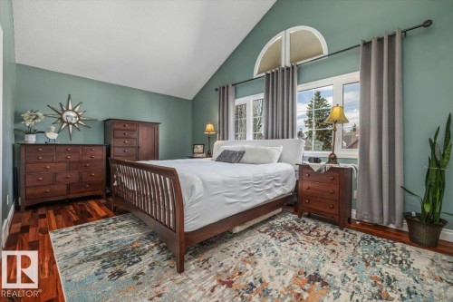 Vaulted ceiling featuring wood-finish flooring and a large window with an arched transom - 6003 176 Street, Edmonton, AB - Indoor Photo Showing Bedroom