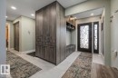 Entryway featuring a decorative frosted glass front door and a built-in mudroom bench - 6003 176 Street, Edmonton, AB  - Indoor Photo Showing Other Room 