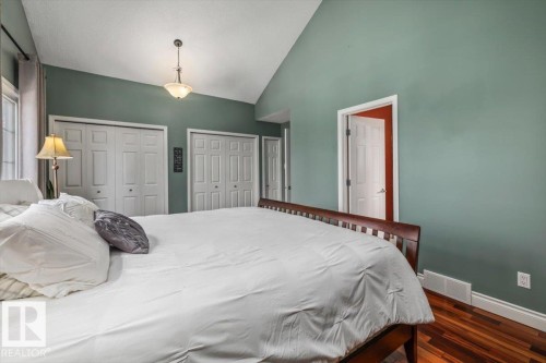 Vaulted ceiling room featuring rich wood-finish flooring - 6003 176 Street, Edmonton, AB - Indoor Photo Showing Bedroom