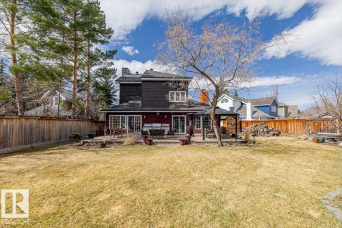 Expansive backyard featuring a large patio, mature trees, and a privacy fence - 6003 176 Street, Edmonton, AB - Outdoor