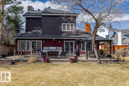 Rear exterior featuring a large concrete patio, built-in outdoor kitchen, and a covered gazebo - 6003 176 Street, Edmonton, AB - Outdoor
