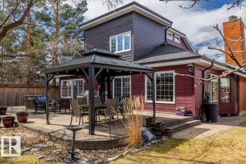 Two-story property with brick and horizontal siding, featuring multiple windows with grids - 6003 176 Street, Edmonton, AB - Outdoor