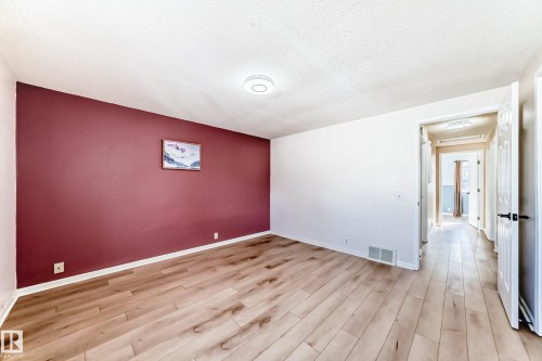 The room features light wood flooring, a ceiling-mounted light fixture, and a white ceiling - 4224 30 Street, Edmonton, AB - Indoor Photo Showing Other Room