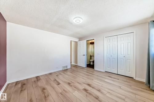 This room features light-toned wood flooring, light-colored walls, and a white ceiling with a flush-mount light fixture - 4224 30 Street, Edmonton, AB - Indoor Photo Showing Other Room