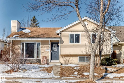 The property features light-colored horizontal siding, a dark front door, and a brown shingled roof - 4224 30 Street, Edmonton, AB - Outdoor