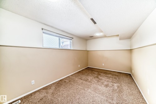 This room features neutral-toned walls with a two-tone paint scheme, a window with blinds, and recessed lighting - 4224 30 Street, Edmonton, AB - Indoor Photo Showing Other Room