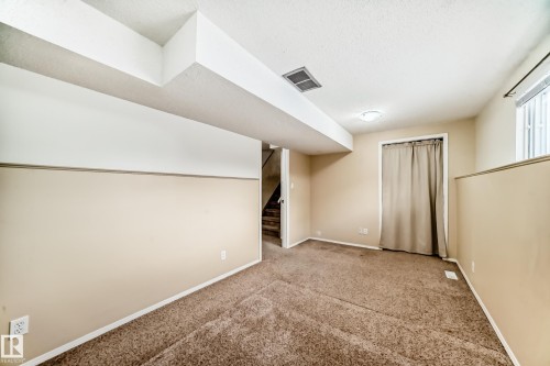 Spacious room with carpeted flooring, light-colored walls, a window, and overhead lighting - 4224 30 Street, Edmonton, AB - Indoor Photo Showing Other Room