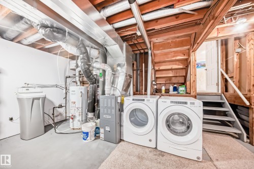 The utility area features a water heater, furnace, and a washer and dryer - 4224 30 Street, Edmonton, AB - Indoor Photo Showing Laundry Room