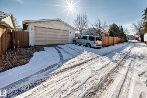 The property includes a detached garage with a light-colored garage door and a driveway - 4224 30 Street, Edmonton, AB - Outdoor