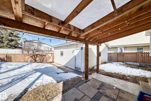 The property features a covered patio with string lights, providing an inviting outdoor space - 4224 30 Street, Edmonton, AB - Outdoor With Exterior