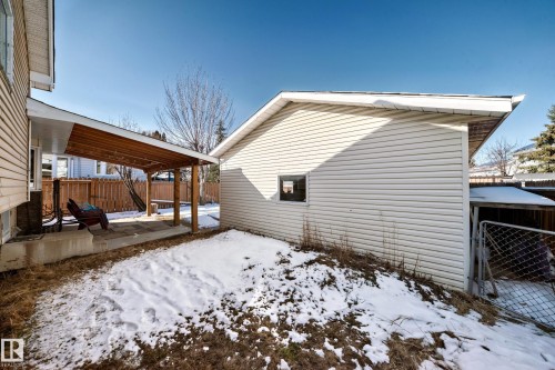 The property features a concrete patio with a wooden pergola and a detached garage with vinyl siding - 4224 30 Street, Edmonton, AB - Outdoor With Exterior