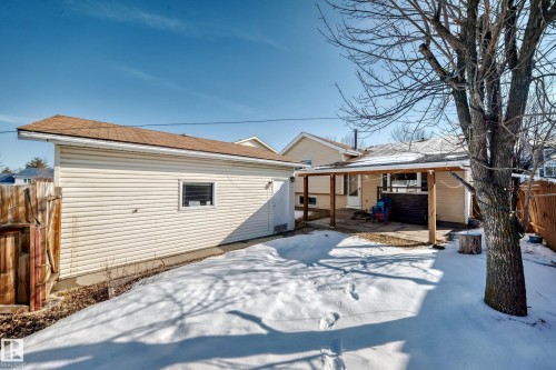 The property features a spacious rear yard with a covered patio area and a detached garage, offering practical outdoor amenities - 4224 30 Street, Edmonton, AB - Outdoor