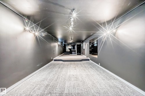 Spacious open room featuring gray walls, dark ceiling, recessed lighting, and light-toned carpet flooring - 5204 112 Avenue, Edmonton, AB - Indoor Photo Showing Other Room