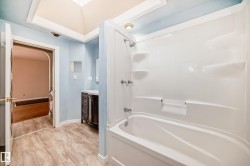 White tub and shower combination with chrome fixtures - 