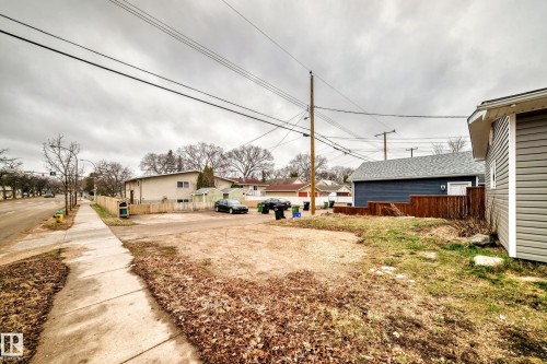 Expansive cleared lot with sidewalk frontage, surrounded by existing residential structures - 5204 112 Avenue, Edmonton, AB - Outdoor
