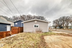 Detached structure featuring light gray horizontal siding and a single window - 