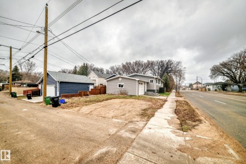 Property featuring a detached garage with a white overhead door and a separate single-car garage - 5204 112 Avenue, Edmonton, AB - Outdoor