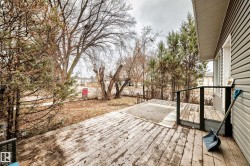 Exterior wood deck with dark railing and gray siding - 