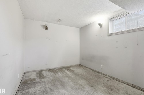Room with a window and two wall-mounted light fixtures - 11211 77 Avenue, Edmonton, AB - Indoor Photo Showing Other Room
