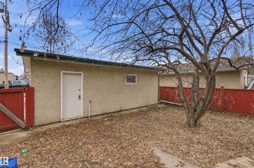 Detached garage with stucco exterior, a single entrance door, and a small window - 11211 77 Avenue, Edmonton, AB - Outdoor