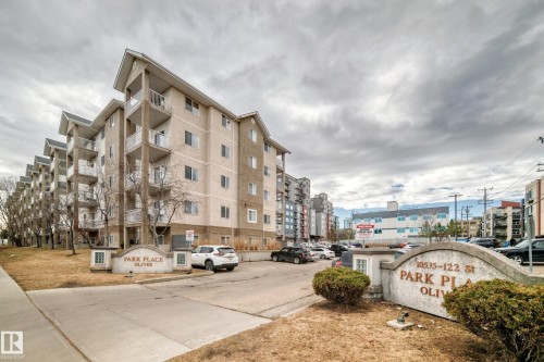Multi-story residential building featuring a light-colored brick and stucco facade - 218 10535 122 Street, Edmonton, AB - Outdoor With Facade