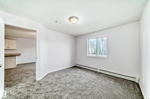 Neutral wall paint throughout - 218 10535 122 Street, Edmonton, AB - Indoor Photo Showing Other Room