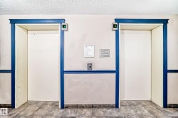 Dual elevators featuring classic blue trim and contemporary call buttons - 