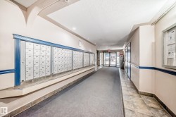 Interior hallway with individual mailboxes and a carpeted walkway - 