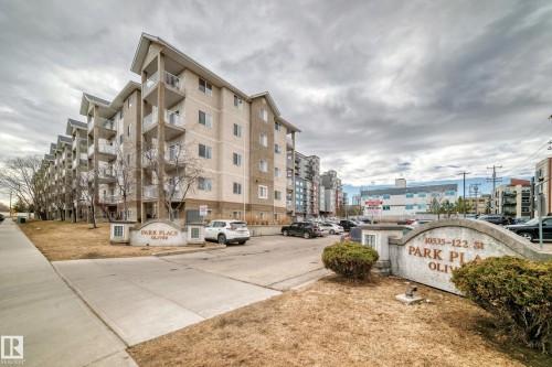 Multi-story residential building with private balconies and a dedicated parking area - 218 10535 122 Street, Edmonton, AB - Outdoor With Facade