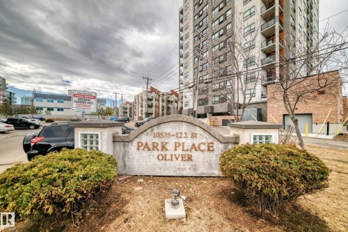 Stone entryway sign for "Park Place Oliver" with established shrubbery - 218 10535 122 Street, Edmonton, AB - Outdoor
