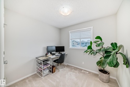 Versatile room featuring light grey walls, carpeted flooring, a white trim window with blinds, and an overhead flush-mount light fixture - 3278 Cherry Crescent, Edmonton, AB - Indoor