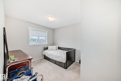 Carpeted room featuring a window with horizontal blinds, light gray wall paint, and a flush-mount ceiling light - 3278 Cherry Crescent, Edmonton, AB - Indoor Photo Showing Bedroom