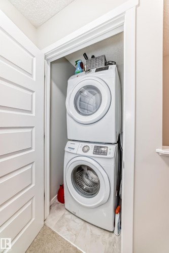 Dedicated laundry closet featuring a stacked washer and dryer unit - 3278 Cherry Crescent, Edmonton, AB - Indoor Photo Showing Laundry Room