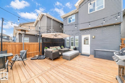 Expansive wood-finish deck with a privacy screen - 3278 Cherry Crescent, Edmonton, AB - Outdoor With Deck Patio Veranda With Exterior