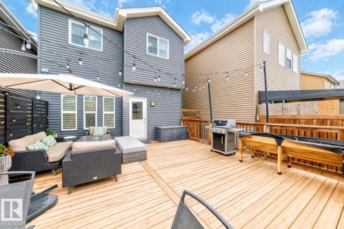 Expansive wood deck with string lighting, privacy fencing, and direct access to the interior - 3278 Cherry Crescent, Edmonton, AB - Outdoor With Deck Patio Veranda With Exterior