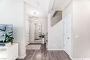 Entryway featuring wood-finish flooring, a modern circular pendant light fixture, and a staircase with carpeted treads - 3278 Cherry Crescent, Edmonton, AB  - Indoor Photo Showing Other Room 